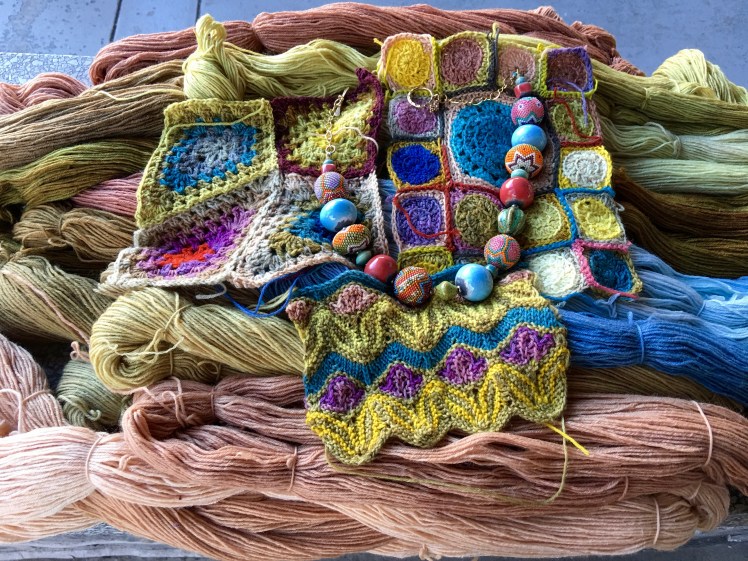 Plant-dyed colors in skeins, crochet, knitting with complementary jewelry