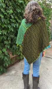 rear view of one face of unfinished machine knit poncho
