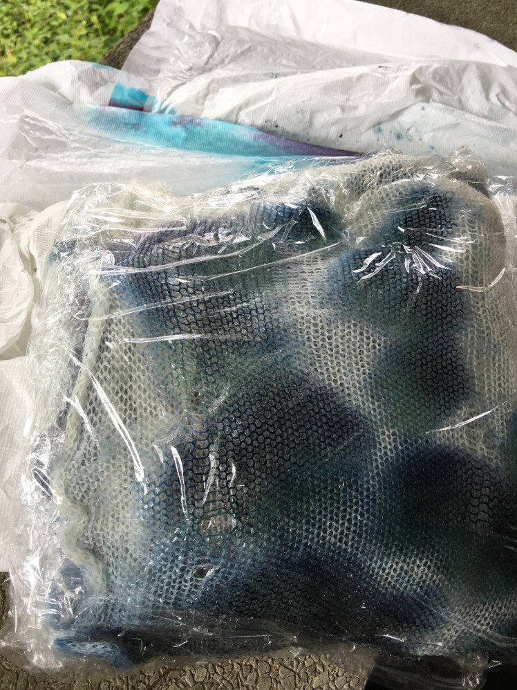 Just-dyed fabric wrapped in plastic wrap to set color in microwave