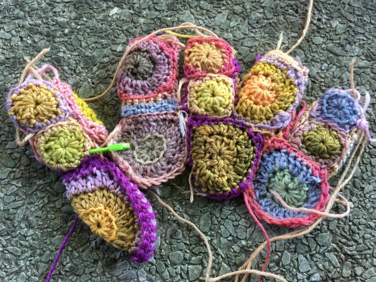 Fingers and thumb joined to hand of patchwork gloves