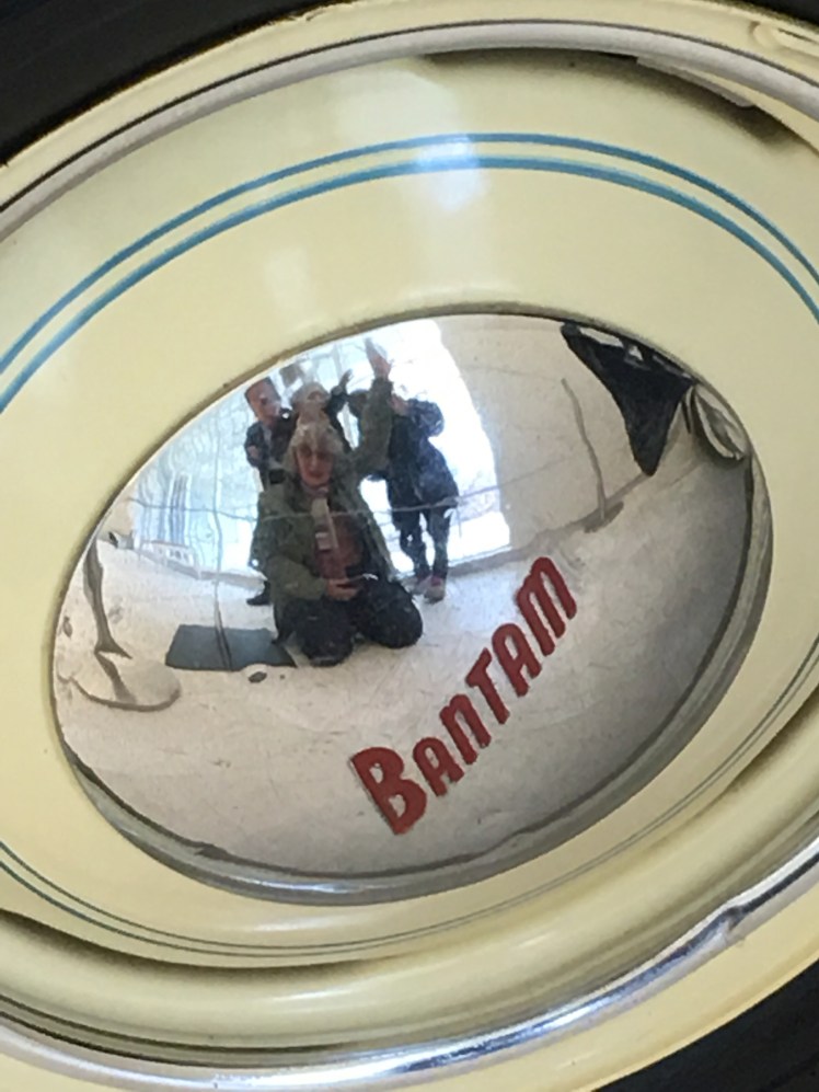 Group photo in hubcap of historical car