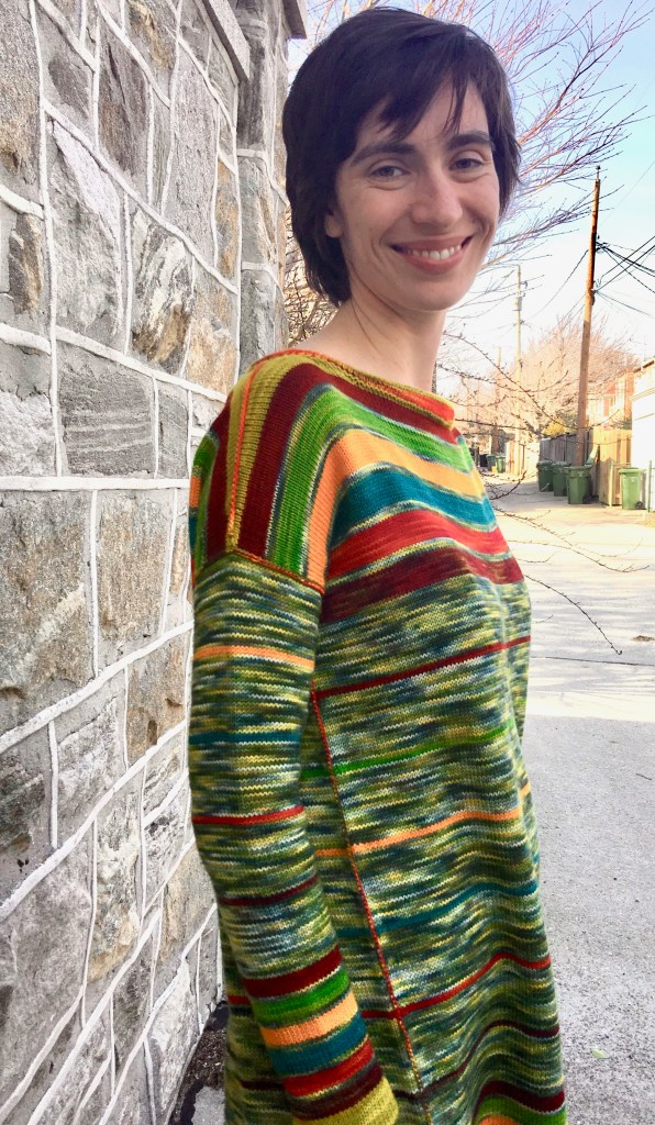 Side view of seaming in striped machine-knit tunic