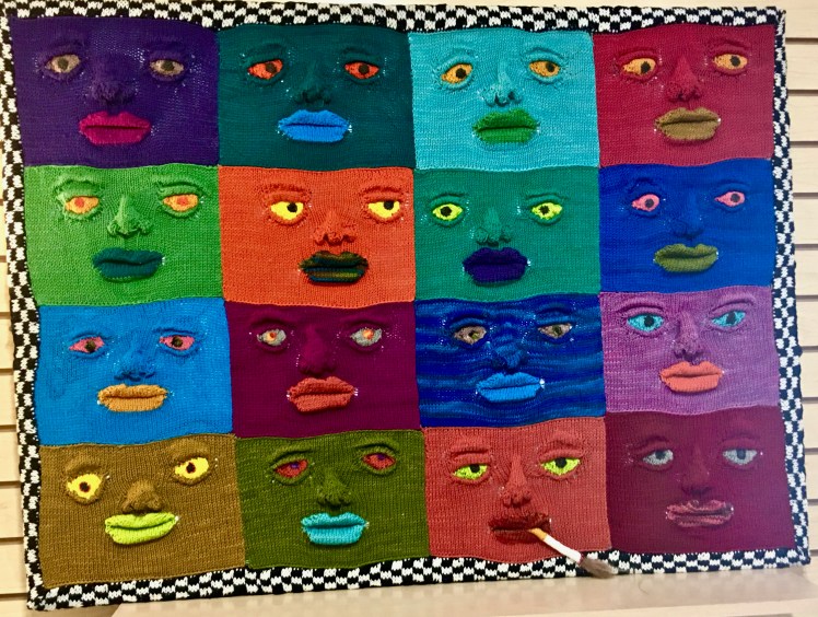 Knitted wallhanging stretched and tied to white foam core