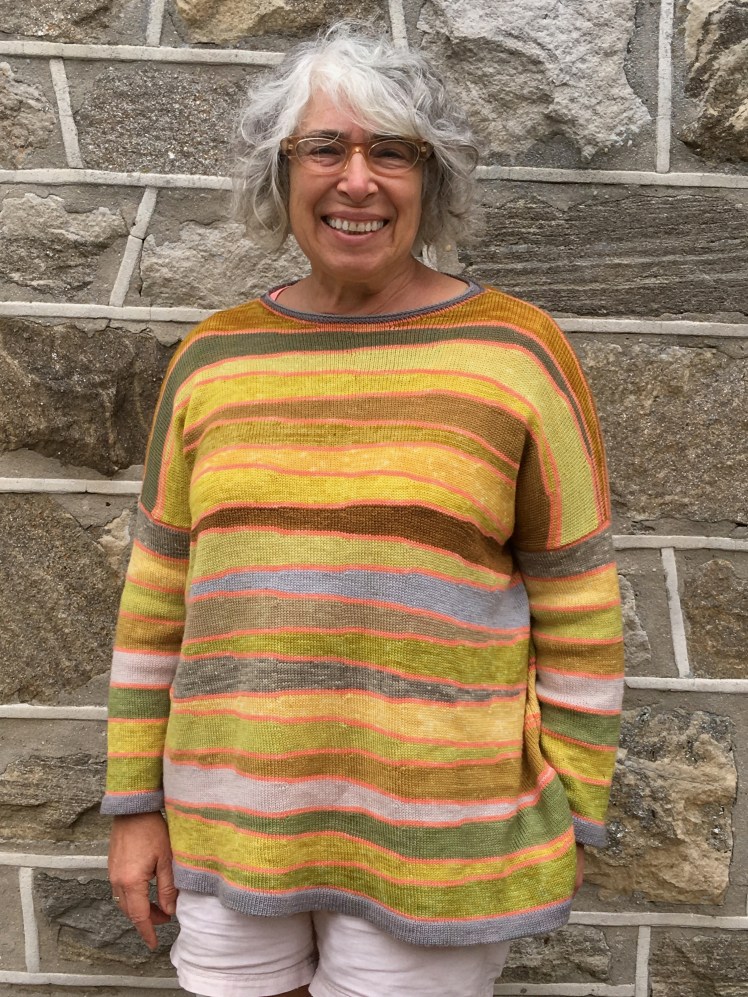 Front view of plant-dyed pullover machine-knit in short-row wedges