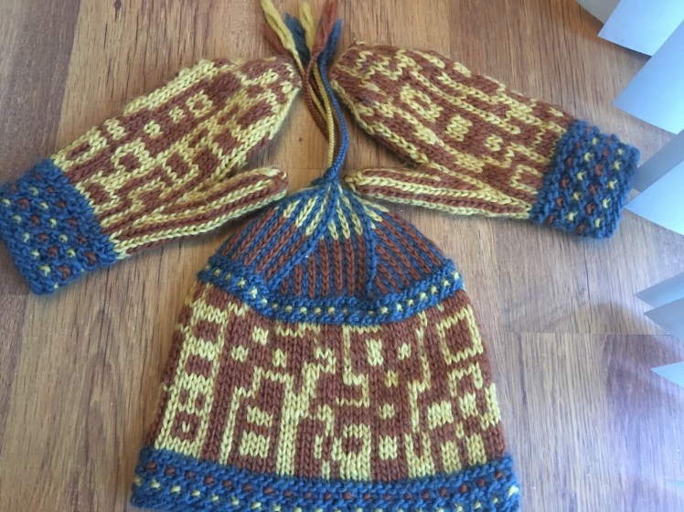 Knitted hat and mittens stranded in improvised pattern combining right-angled shapes