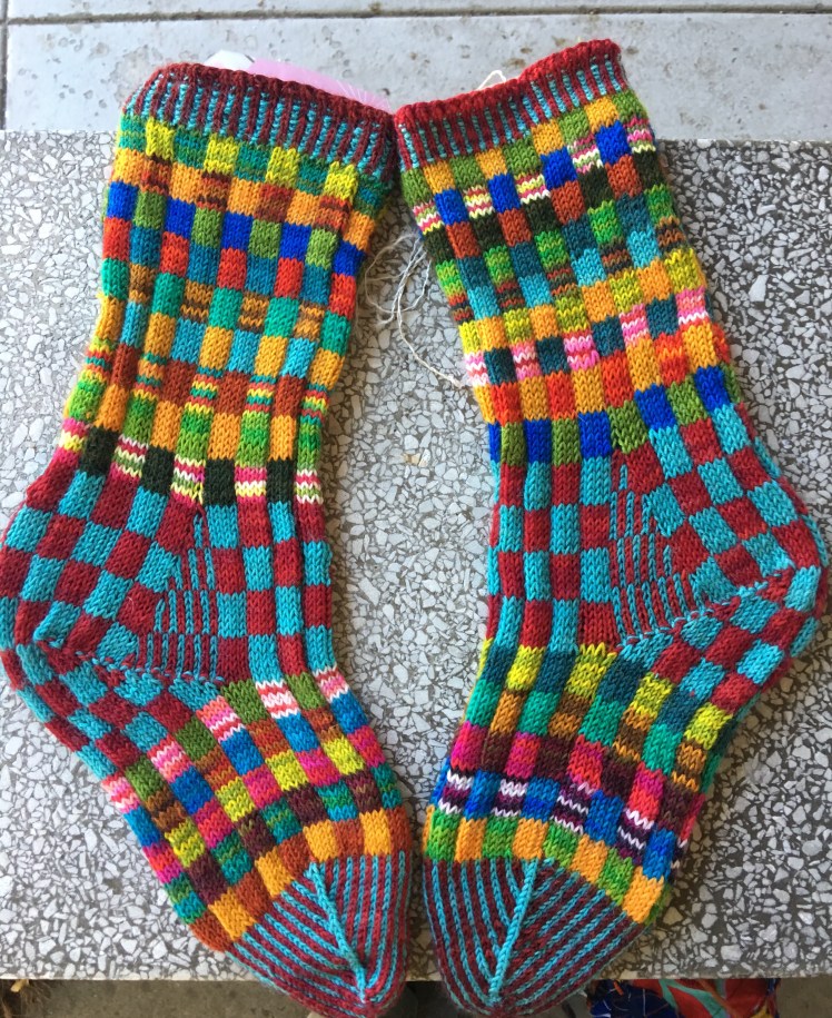 Colorful knitted socks in checkerboard pattern