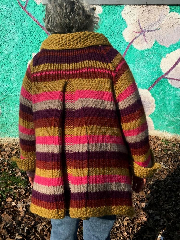Back view of box pleat in modeled knitted coat