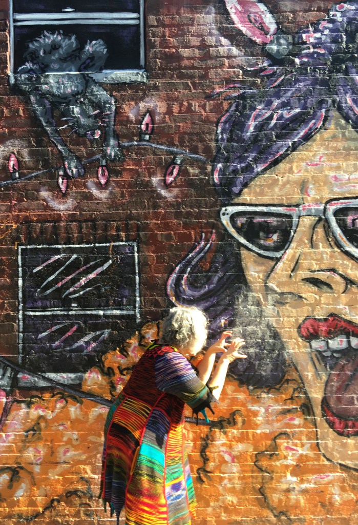 Machine-knit dress with street mural background