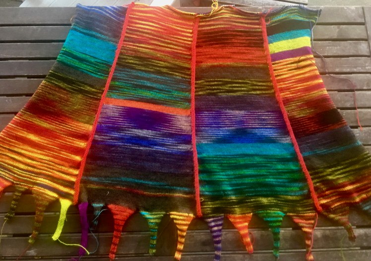 Machine-knit panels joined together for skirt front