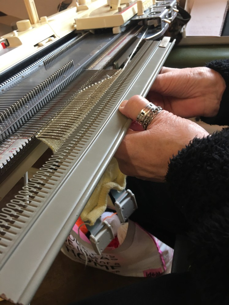 Transferring machine knitting from needles to garter bar