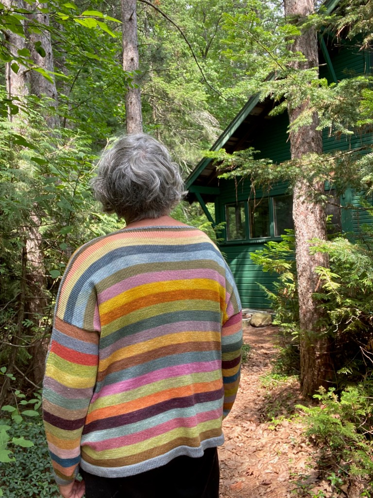 Back view of oversized striped machine-knit pullover