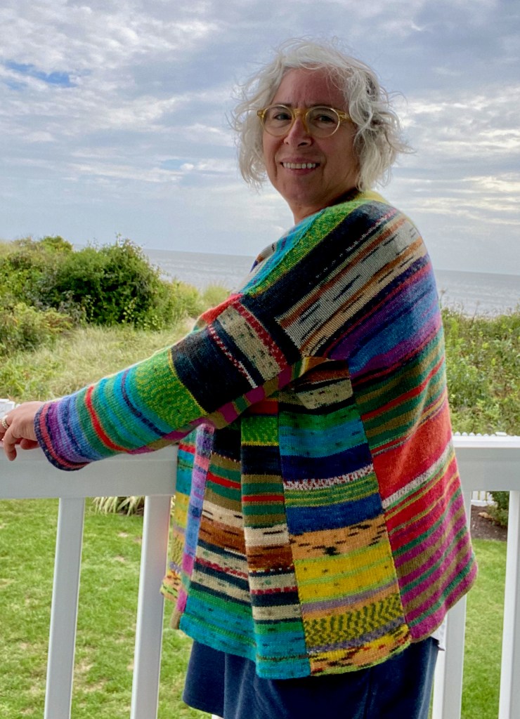 Modeled side view of multi-paneled pullover