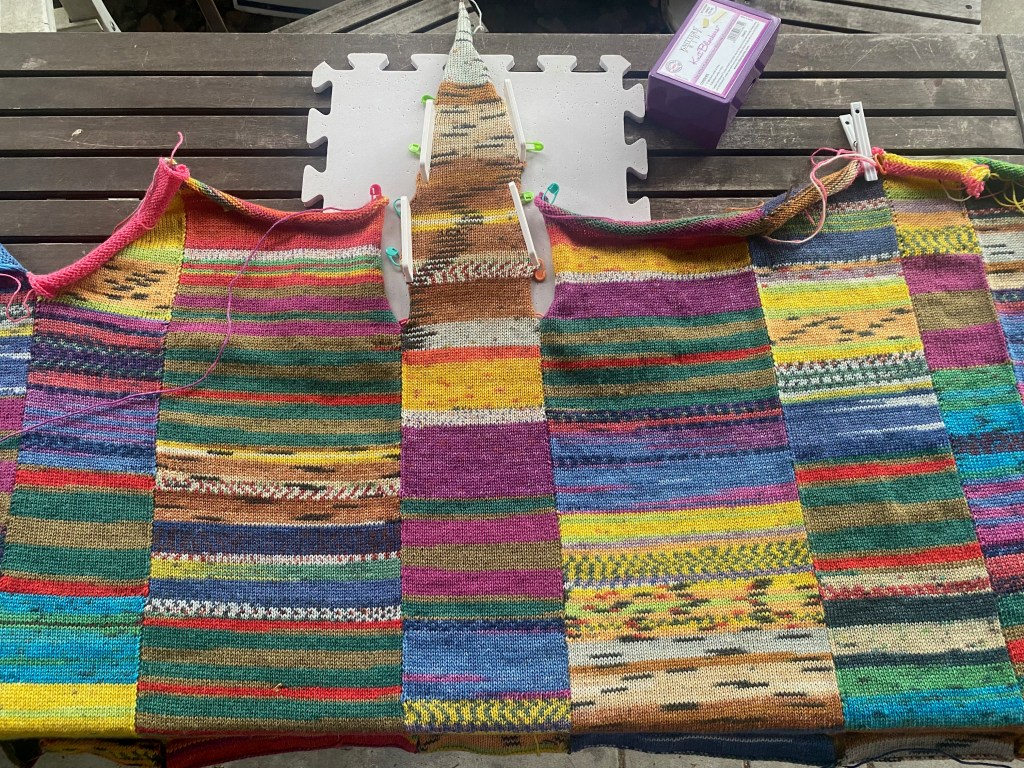 Side panel joins the front and back, then tapers to a triangular point that shapes the sleeve from the bottom