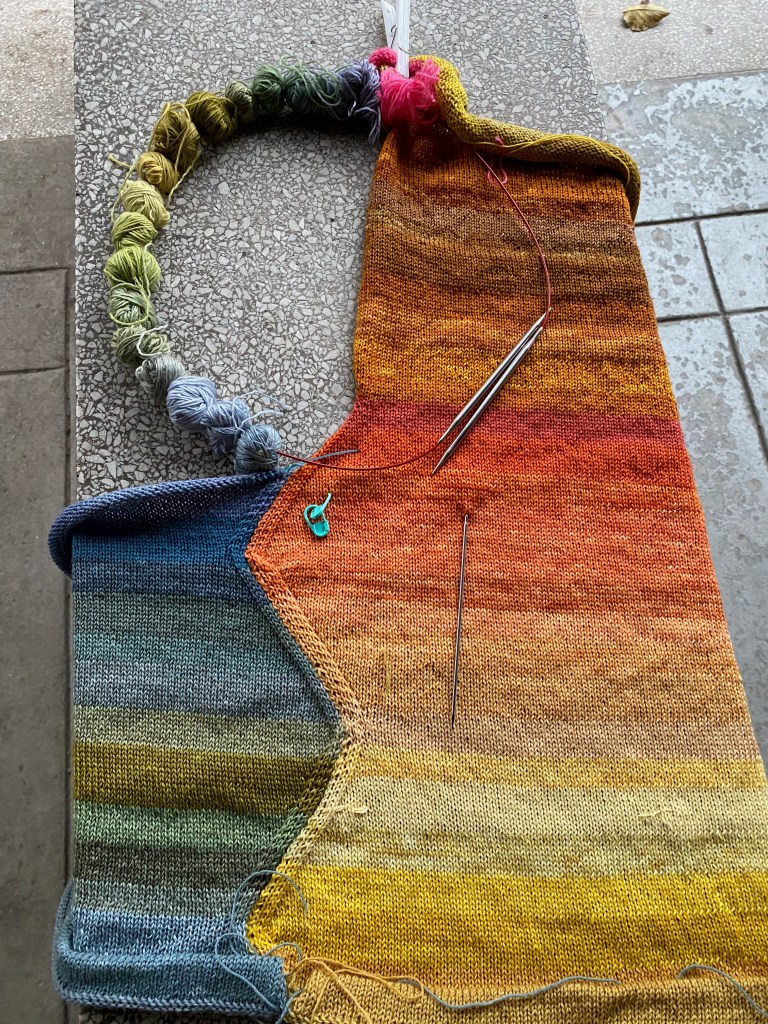 Illustrating the process for correcting a complicated error in constructing a shaped paneled machine knit garment