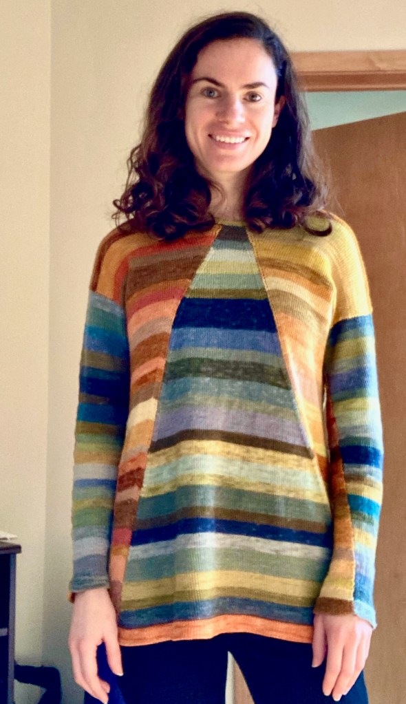 Front view of paneled machine-knit pullover on its intended recipient