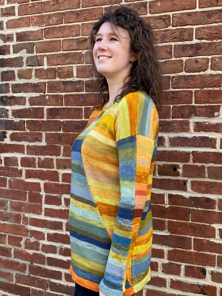 Left side view of paneled machine-knit pullover