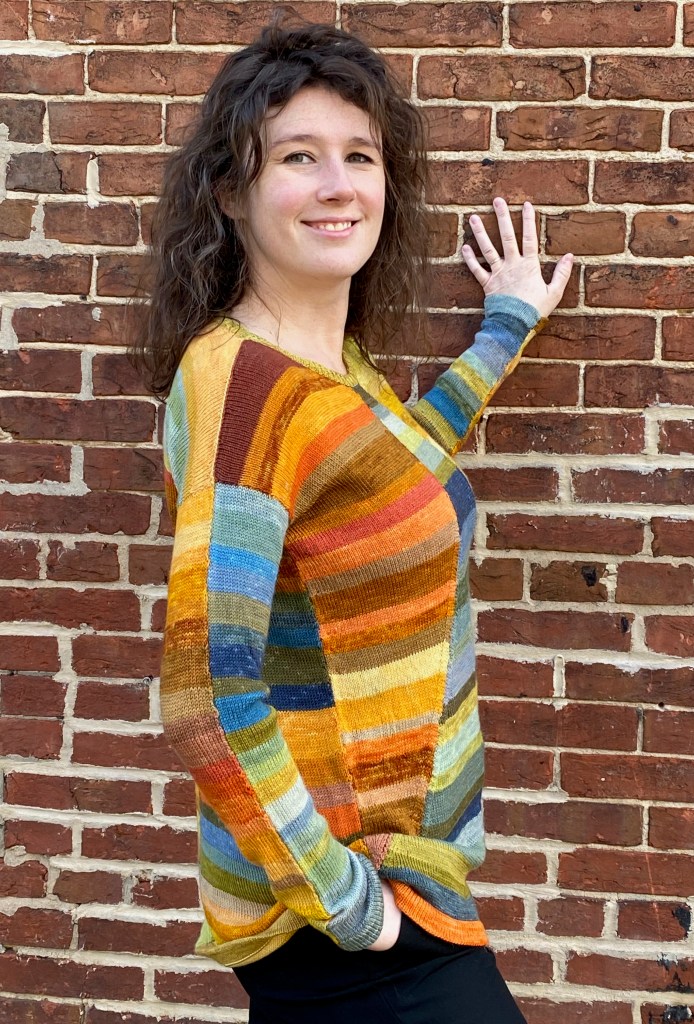 Left side view of paneled machine knit pullover