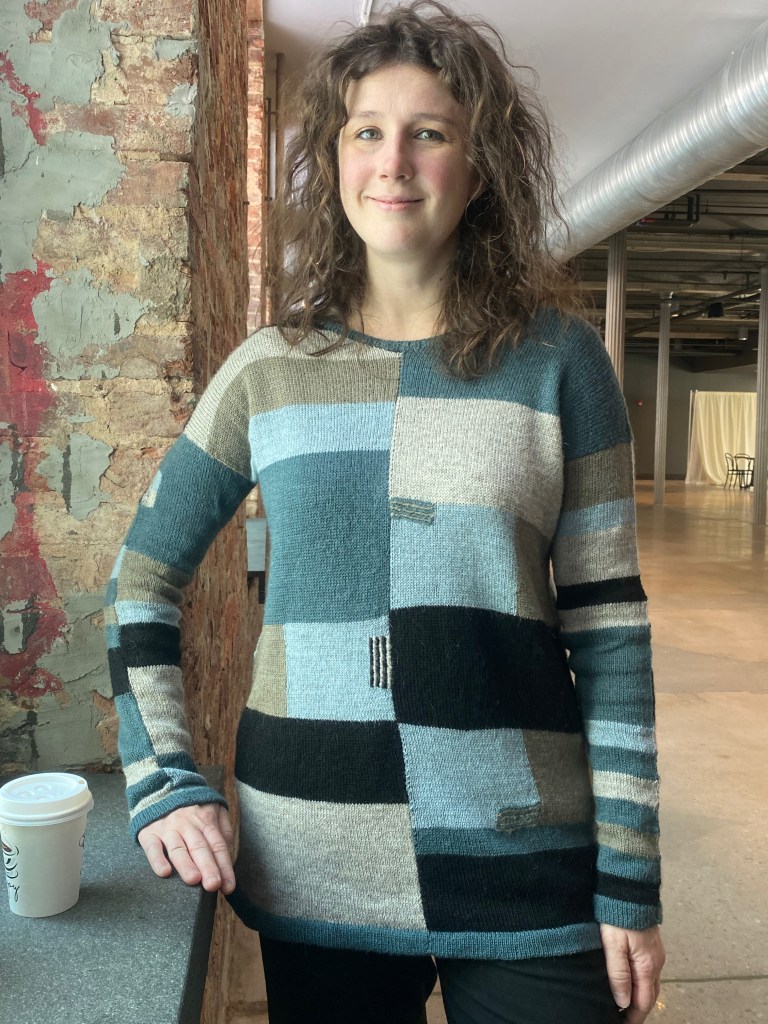 Another front view of pullover with striped embroidered embellishment on intarsia squares