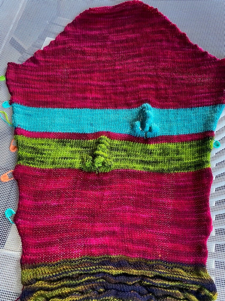 Two machine-knit short-rowed noses  set into stripes on sleeve