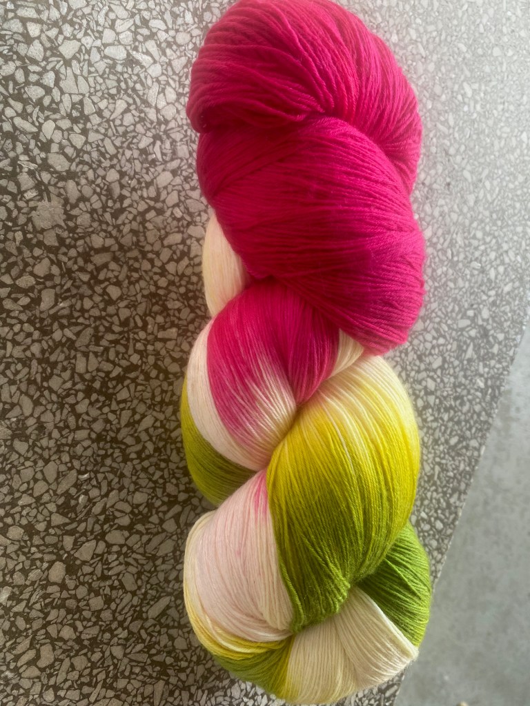 Wollmeise lace in Pitahaya colorway, a multi of rose-pink, leafy greens, and white