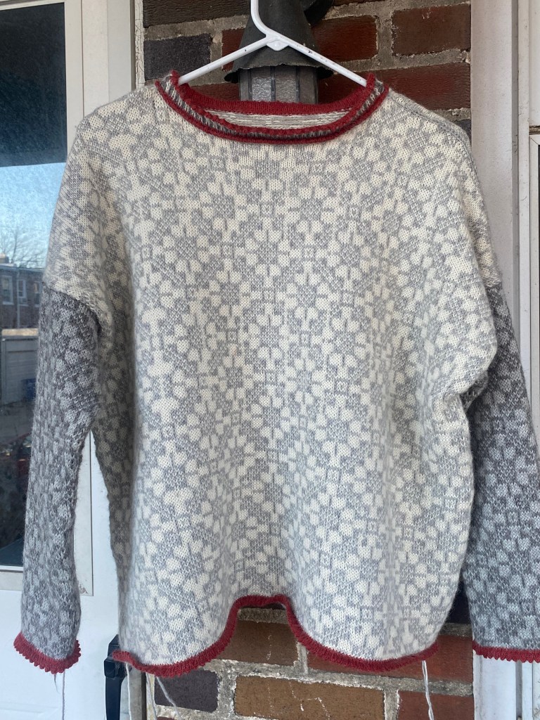 Front of assembled sweater with mispatterning that will be repaired with duplicate stitch embroidery