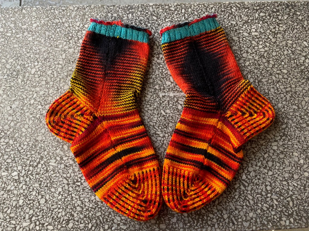 Seamed side of socks with yarn pooling