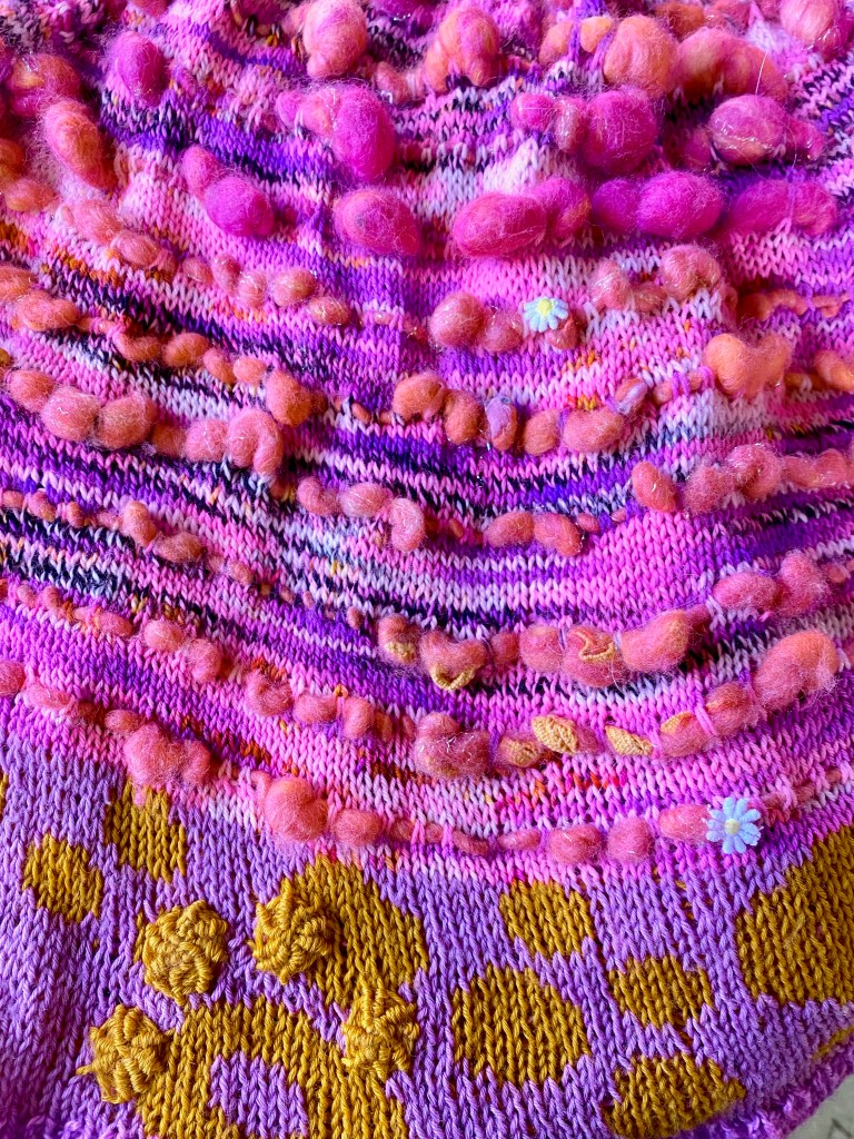 Detail photo of yarns, stranded circles, and embroidered bullions.