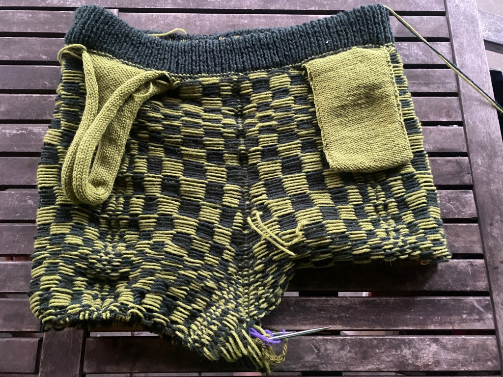 Wrong-side view of the construction of pockets in hand-knitted pants